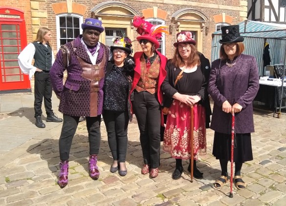 A group of people from the Steampunk Festival, dressed in colourful outfits